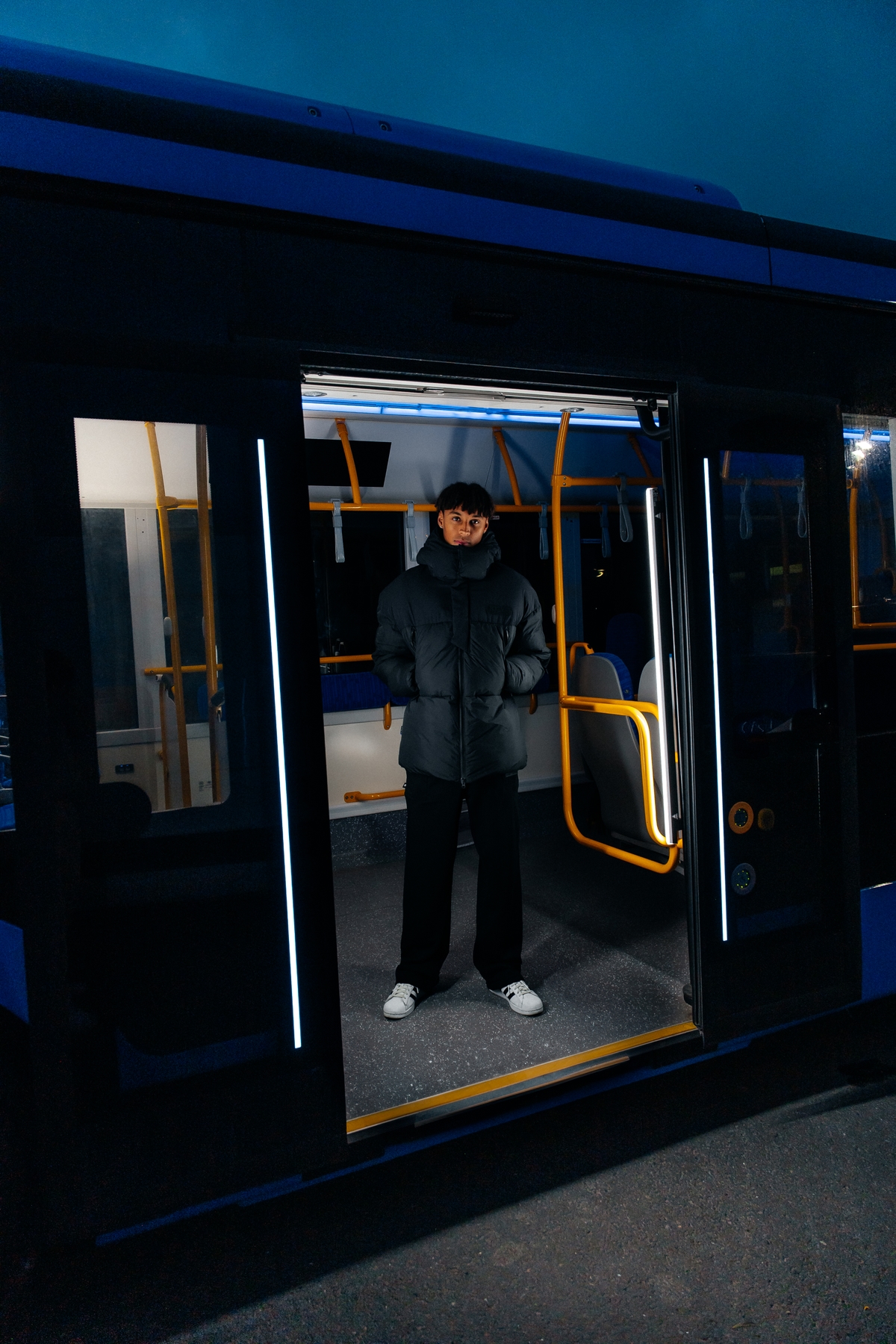 man-black-wintercoat-inside-bus.jpeg