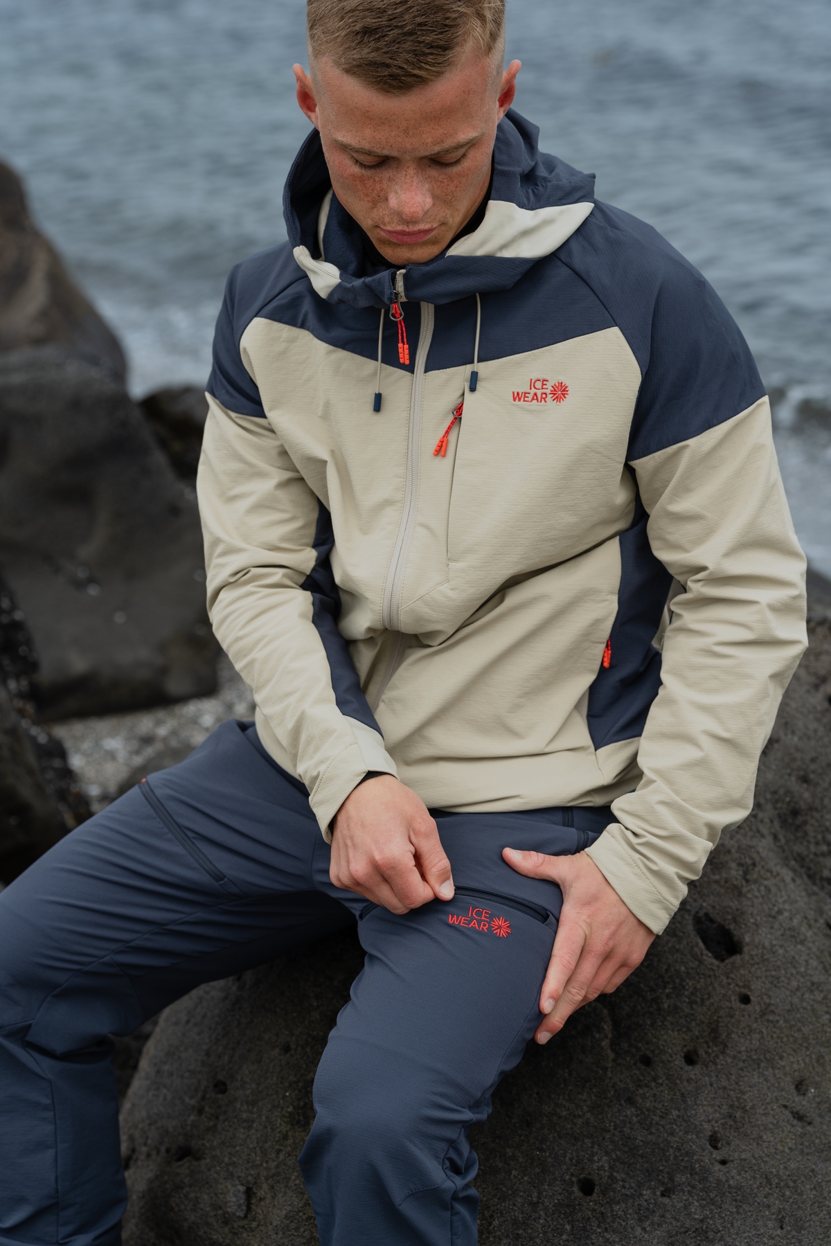man-blue-white-jacket-pants-ocean.jpeg