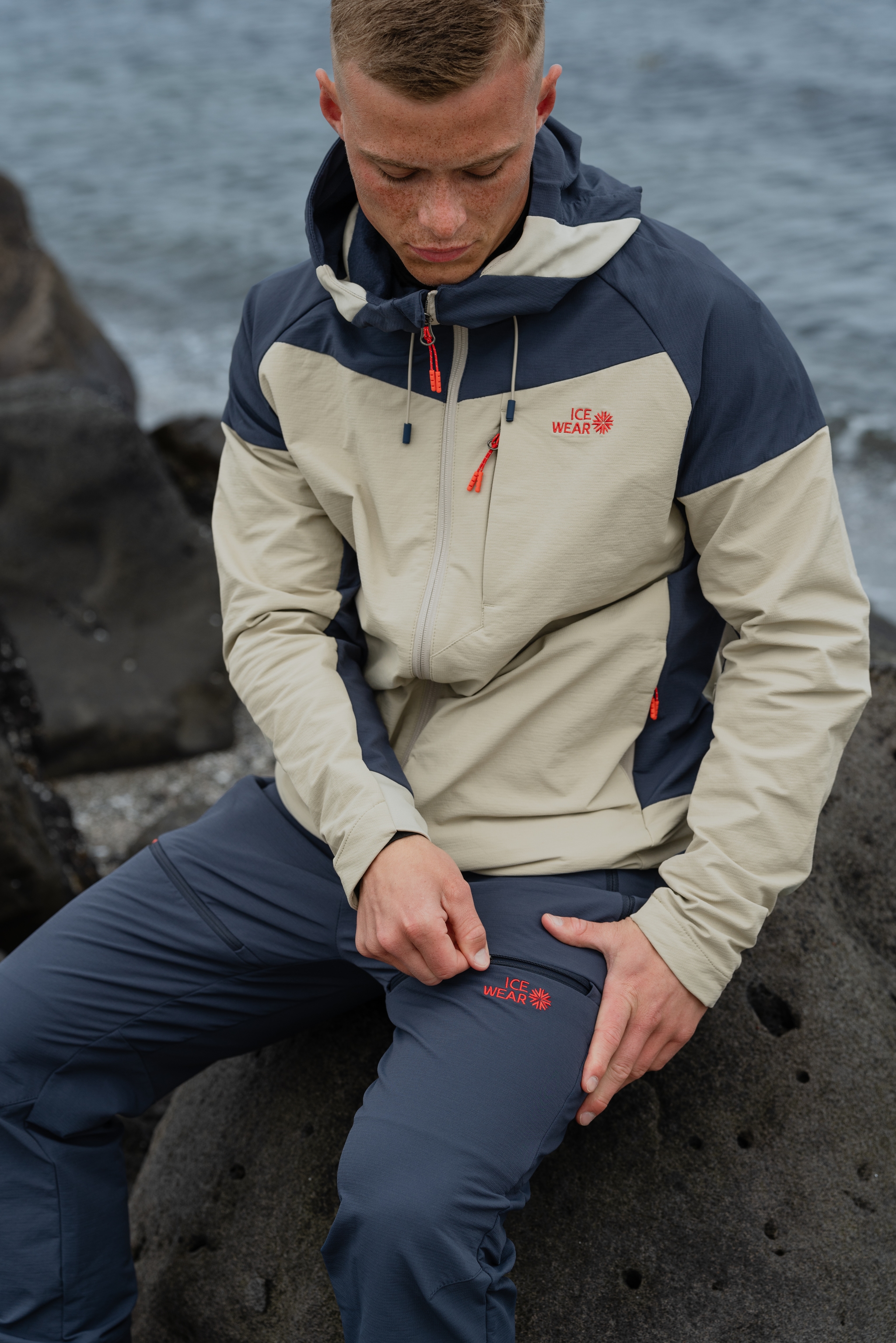 man-blue-white-jacket-pants-ocean.jpeg