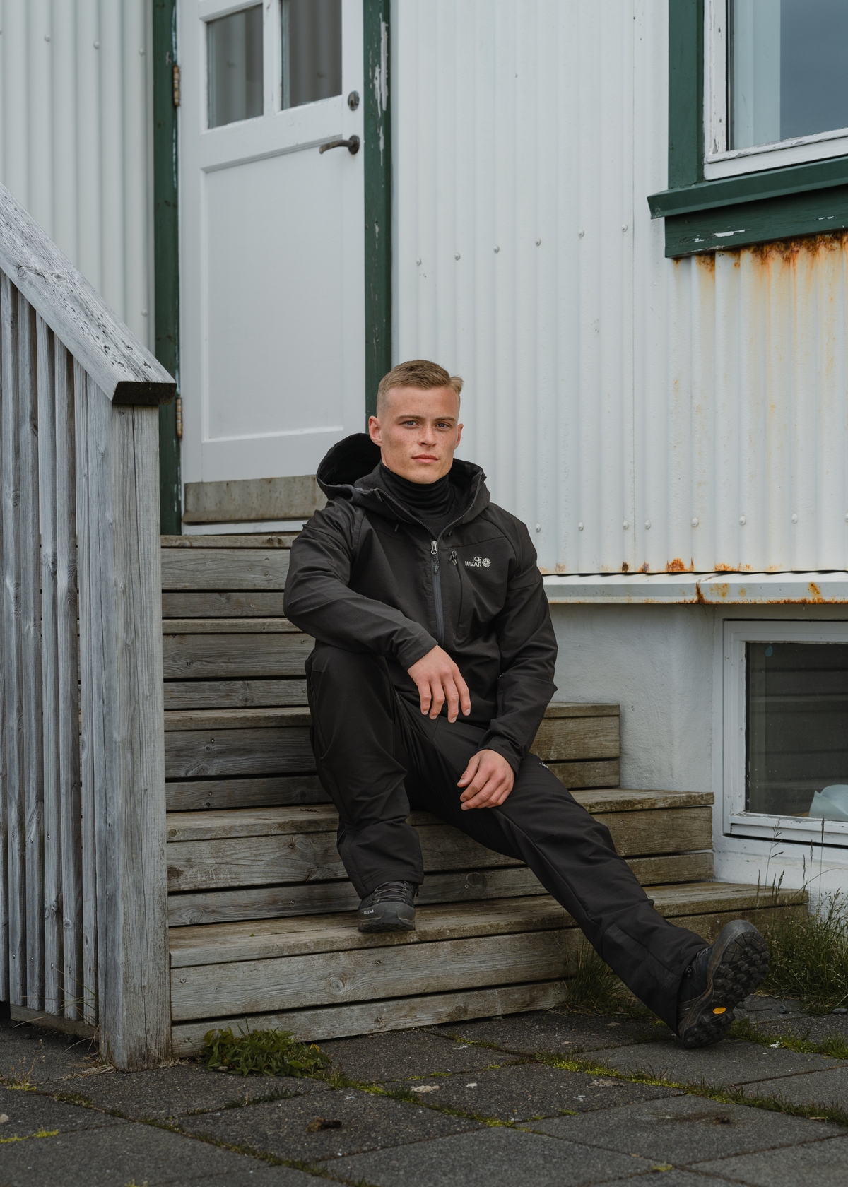 man-black-jacket-pants-house.jpeg
