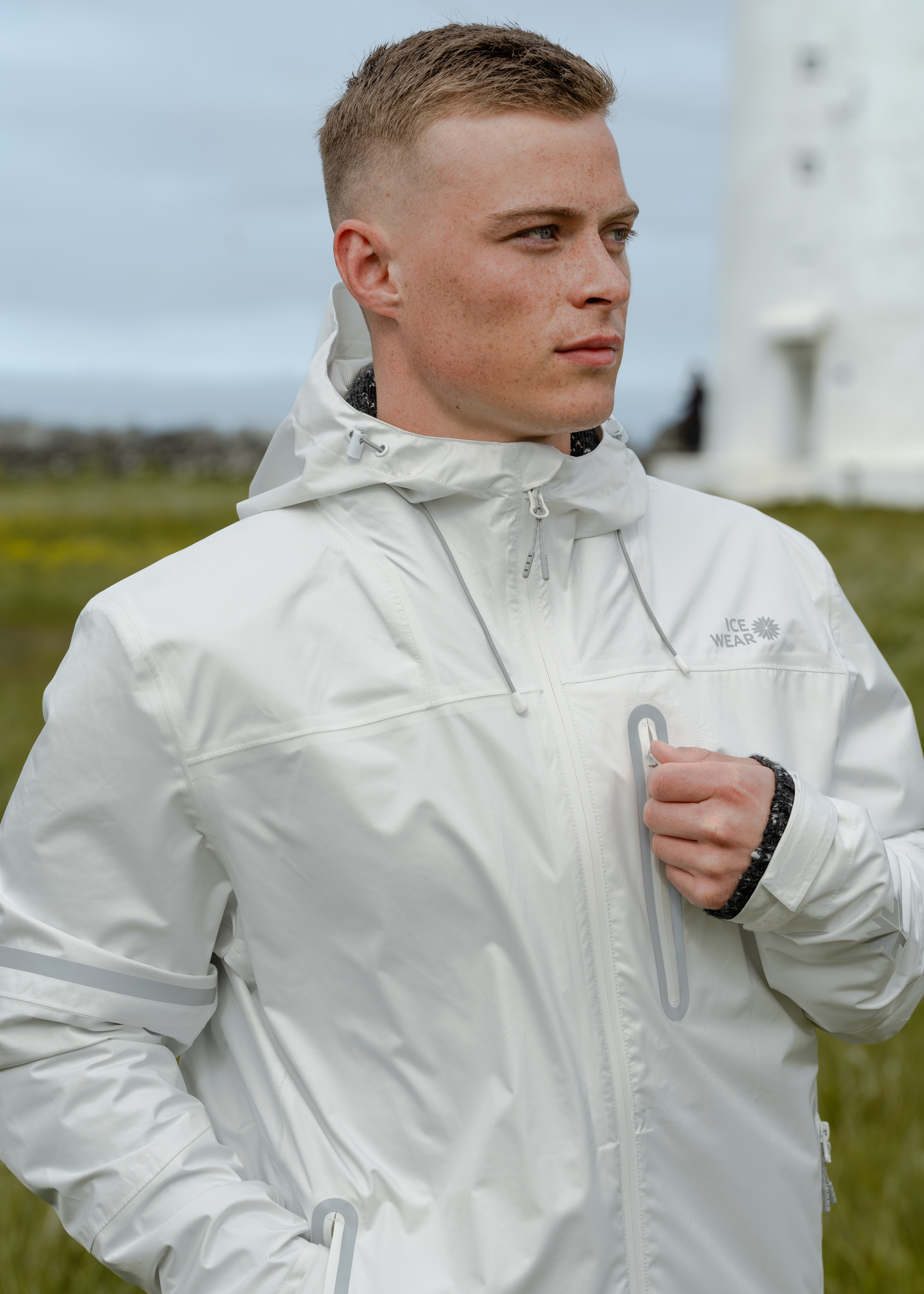 man-white-jacket-lighthouse.jpeg