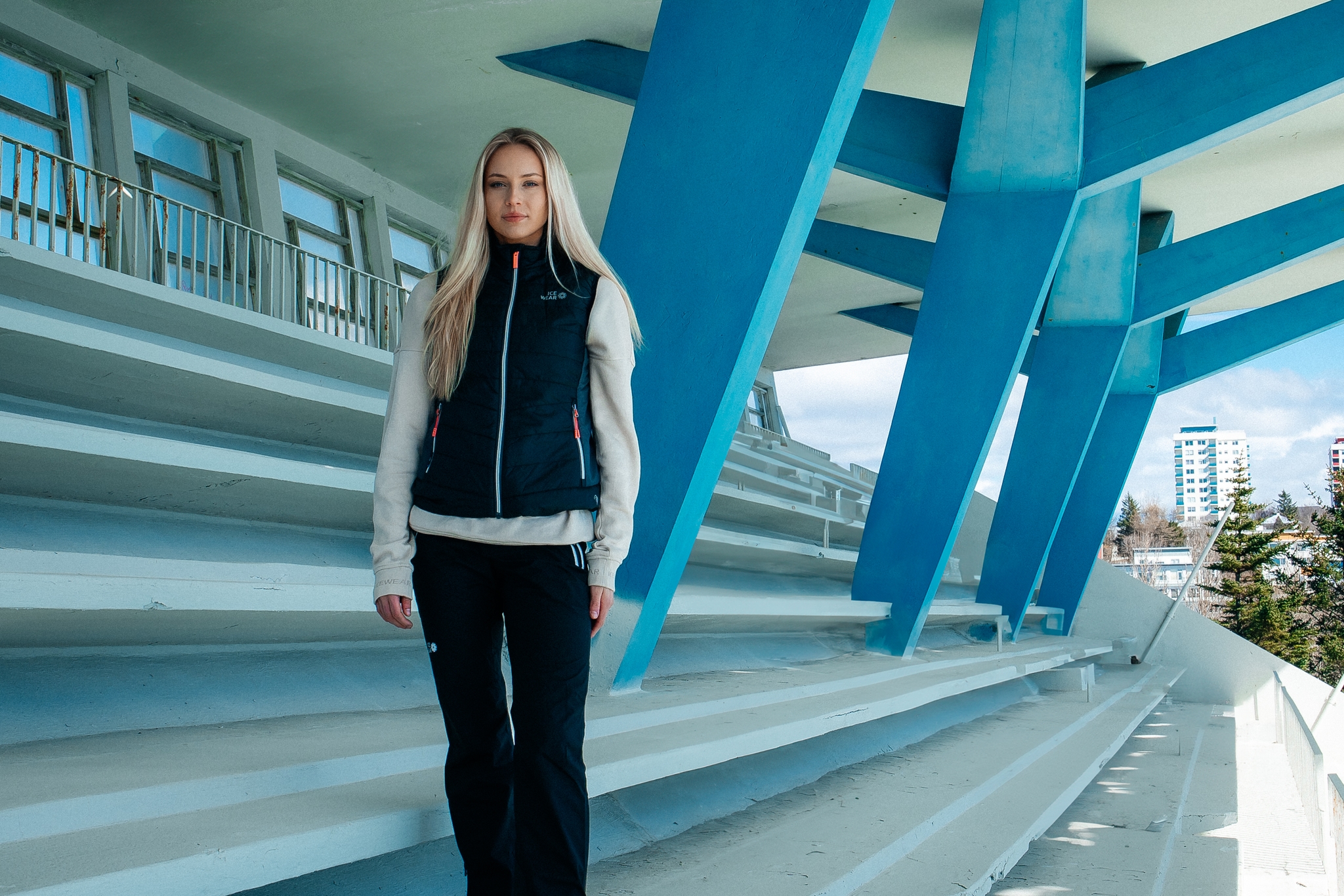woman-blonde-black-vest-pants.jpeg