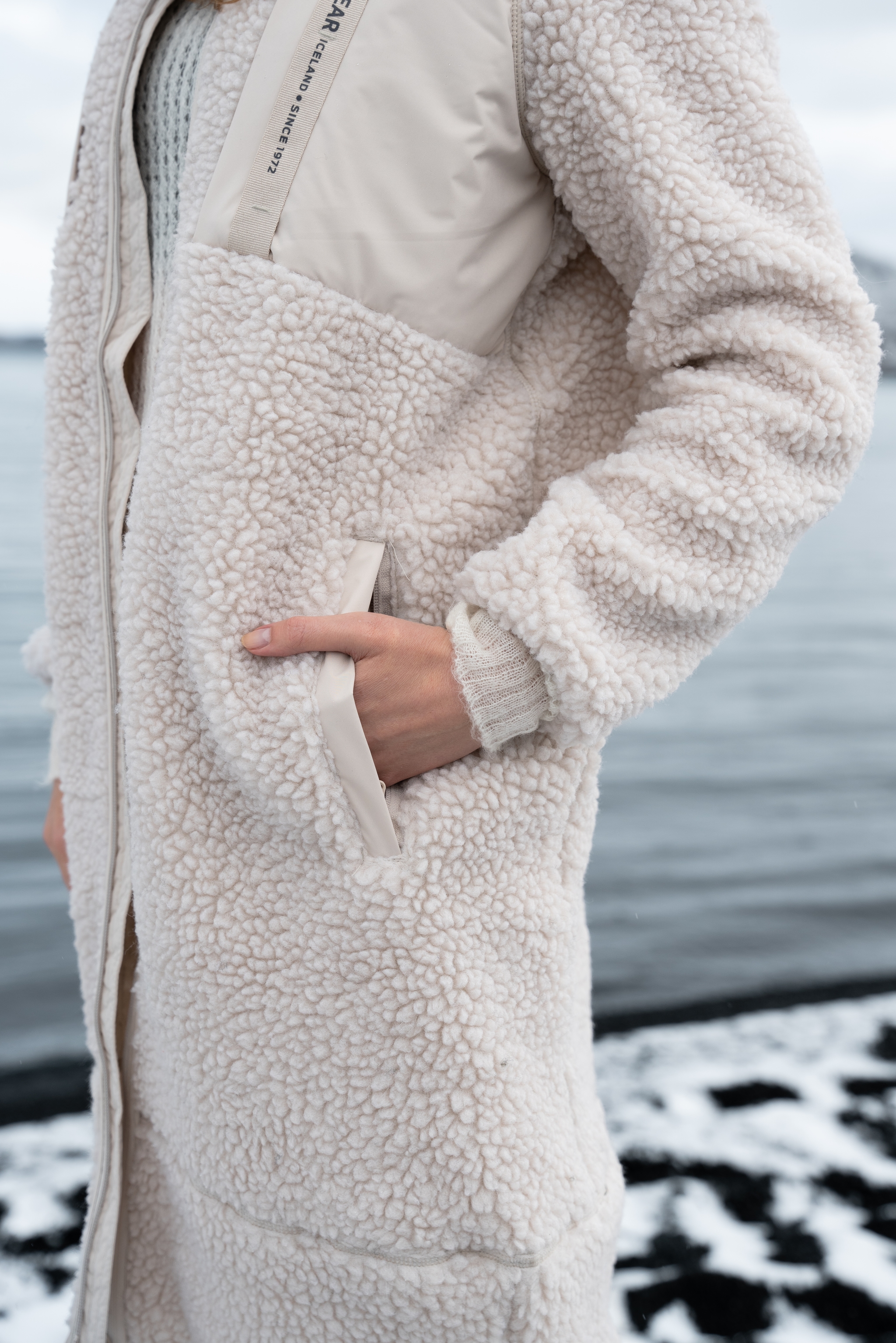 iceland-woman-snow-lake-white-sherpa-coat-7.jpeg