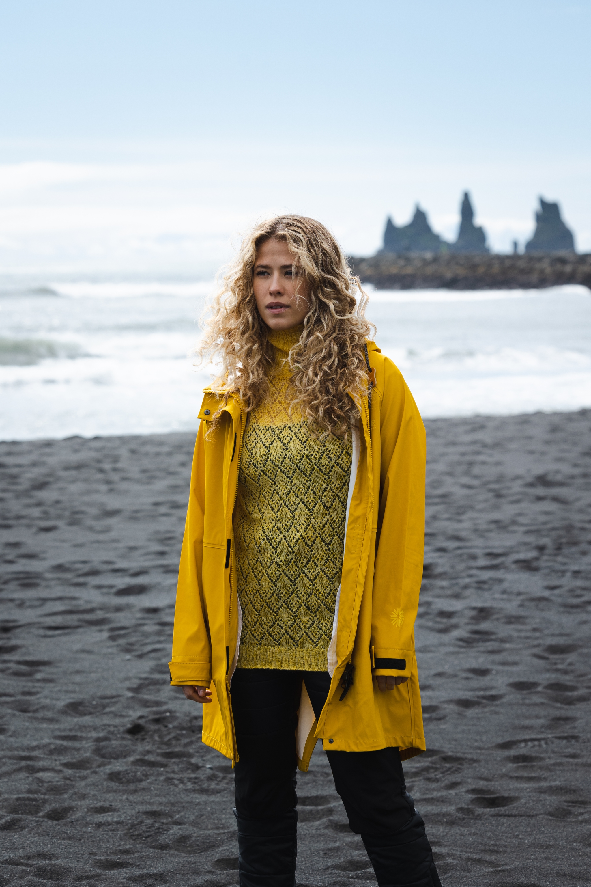 woman-yellow-rainjacket-sweater-blackbeach-2.jpeg