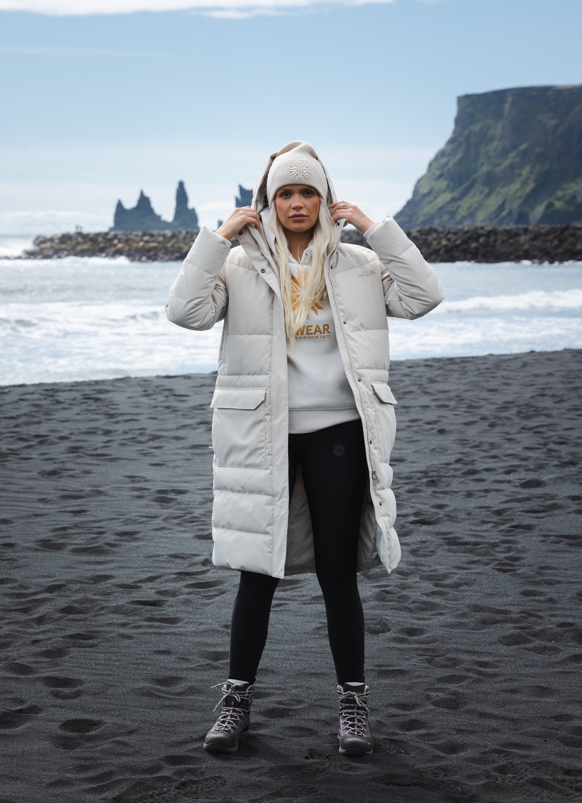 woman-white-long-jacket-blackbeach.jpeg
