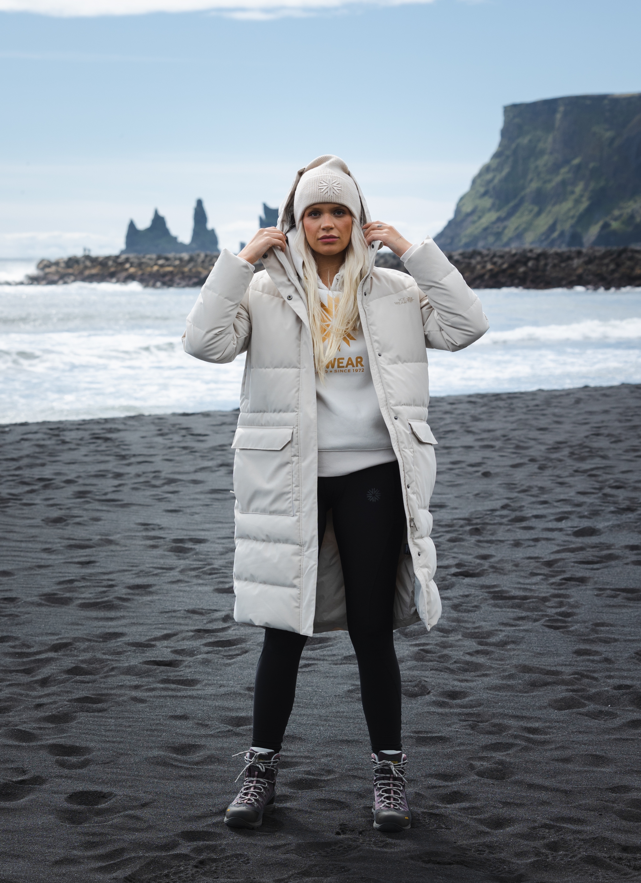 woman-white-long-jacket-blackbeach.jpeg
