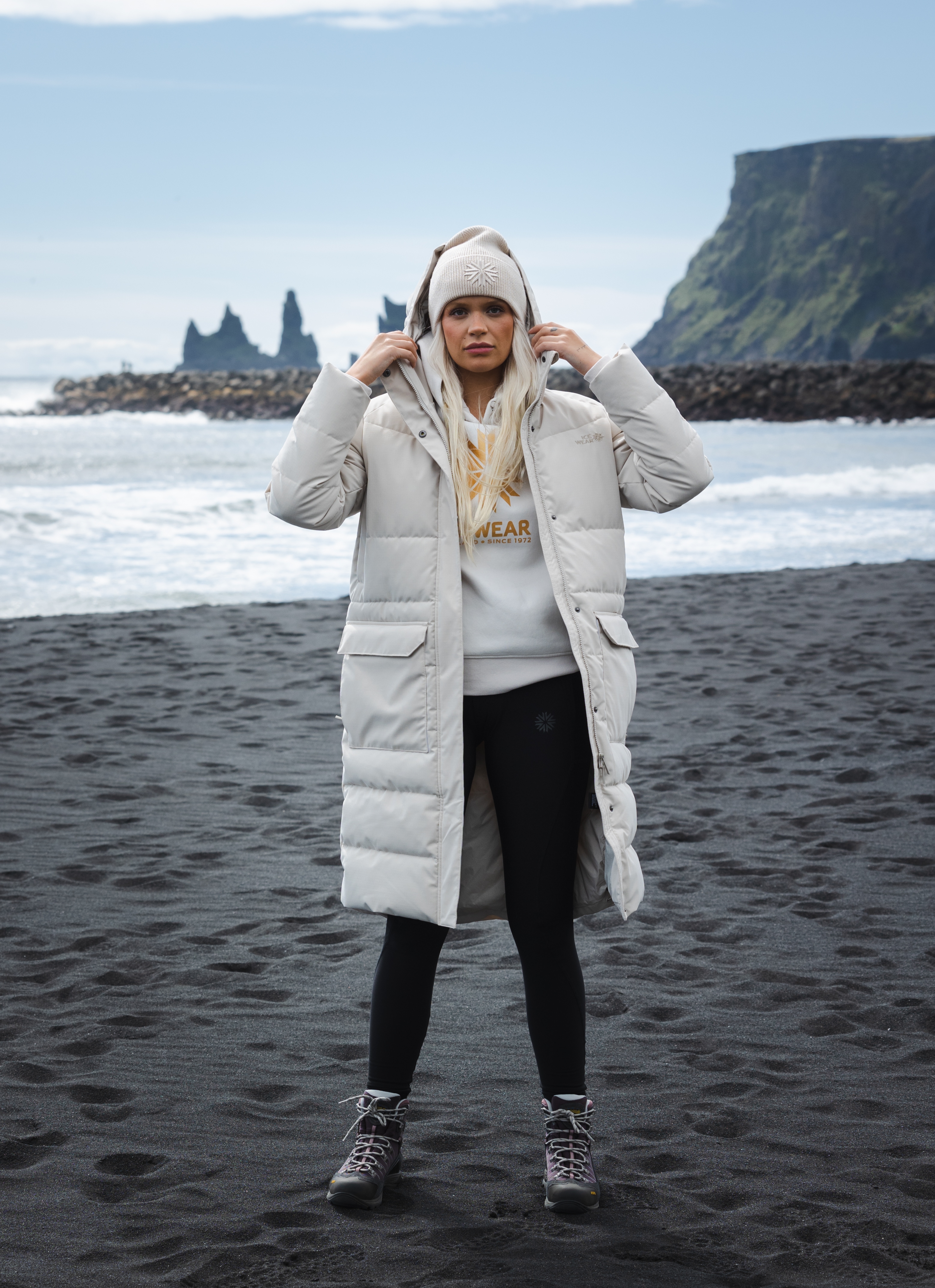 woman-white-long-jacket-blackbeach.jpeg
