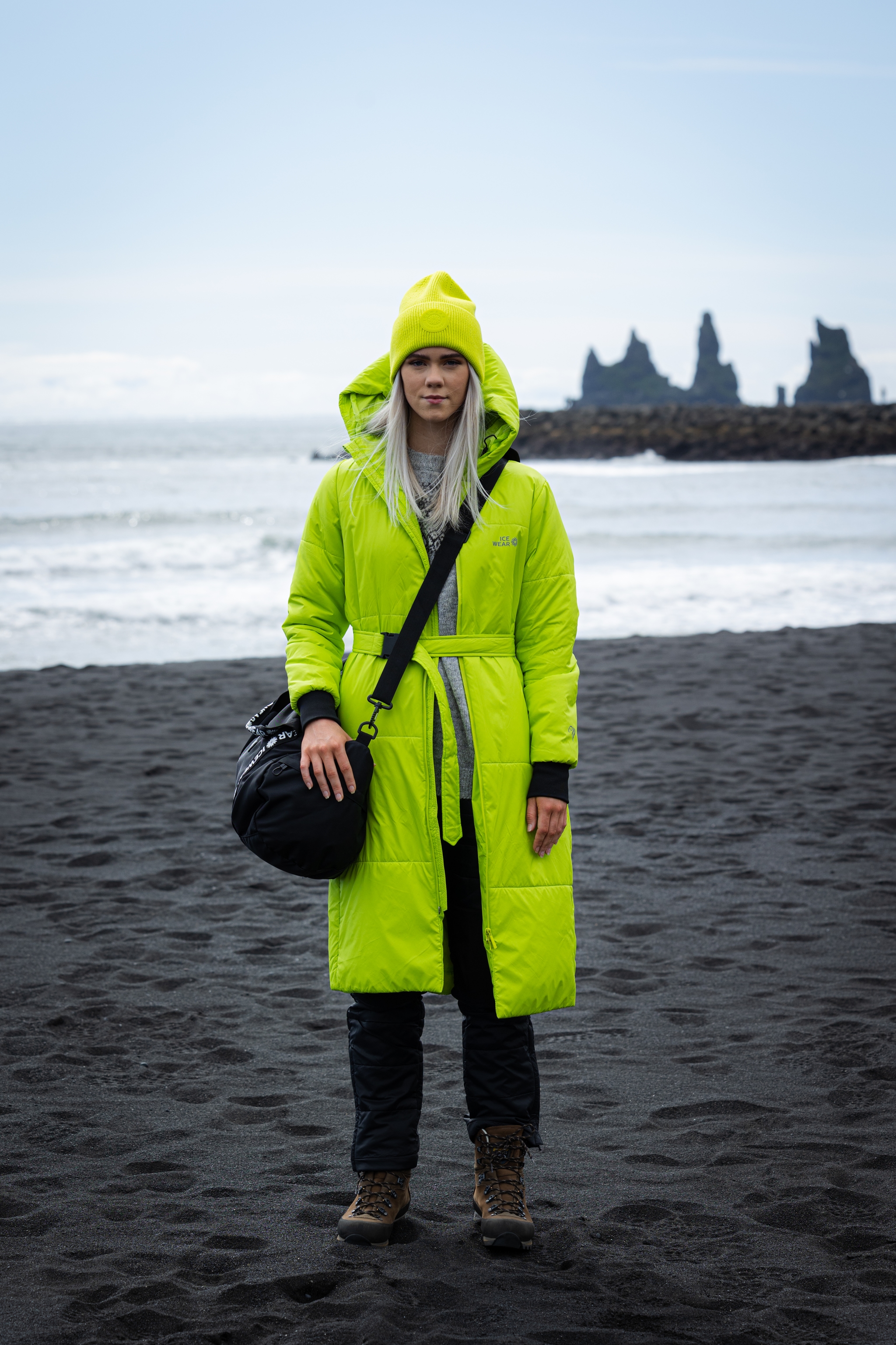 woman-green-jacket-hat-bag-blackbeach.jpeg