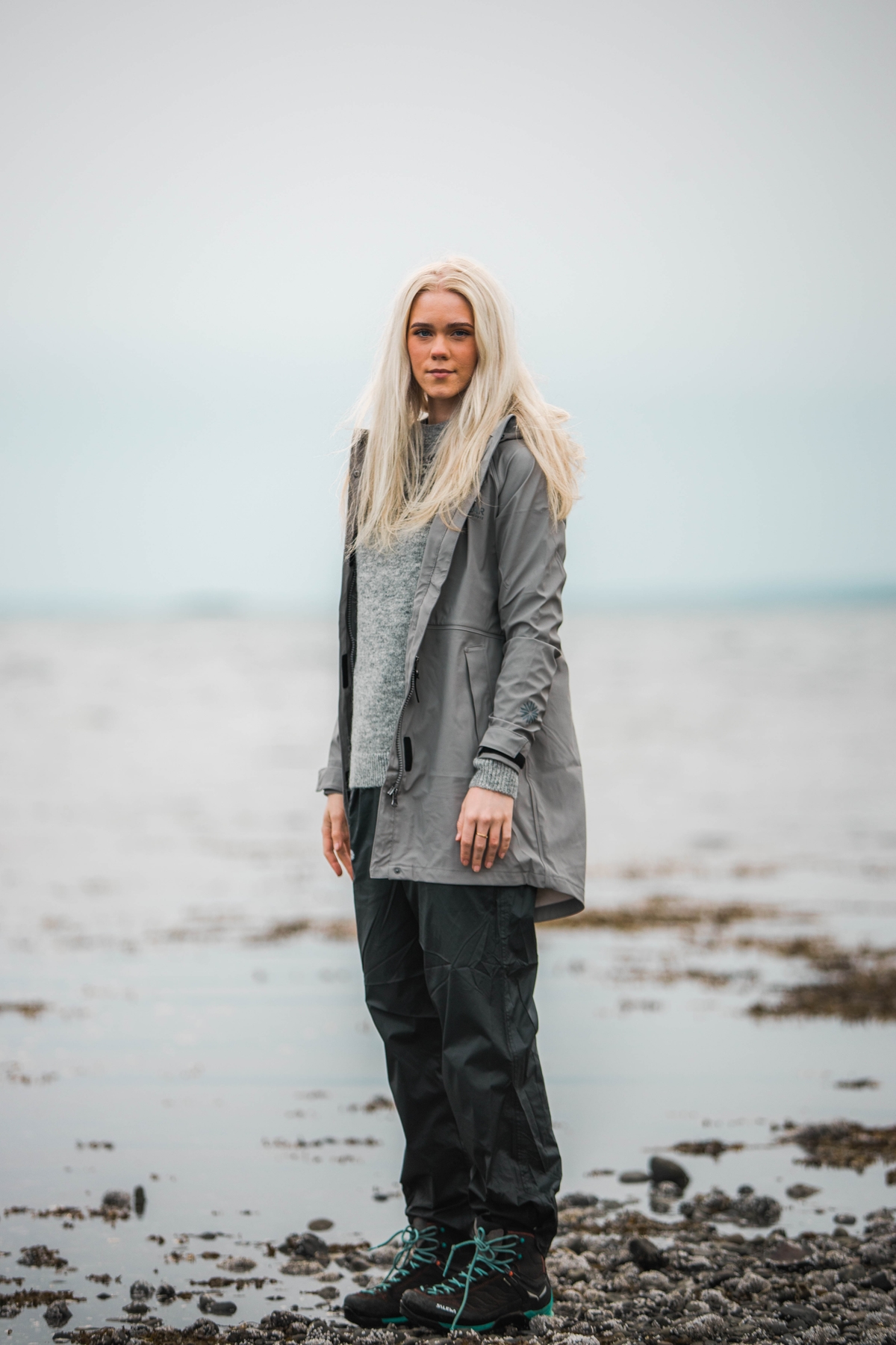 woman-blonde-grey-raincoat-icelandic-beach.jpeg
